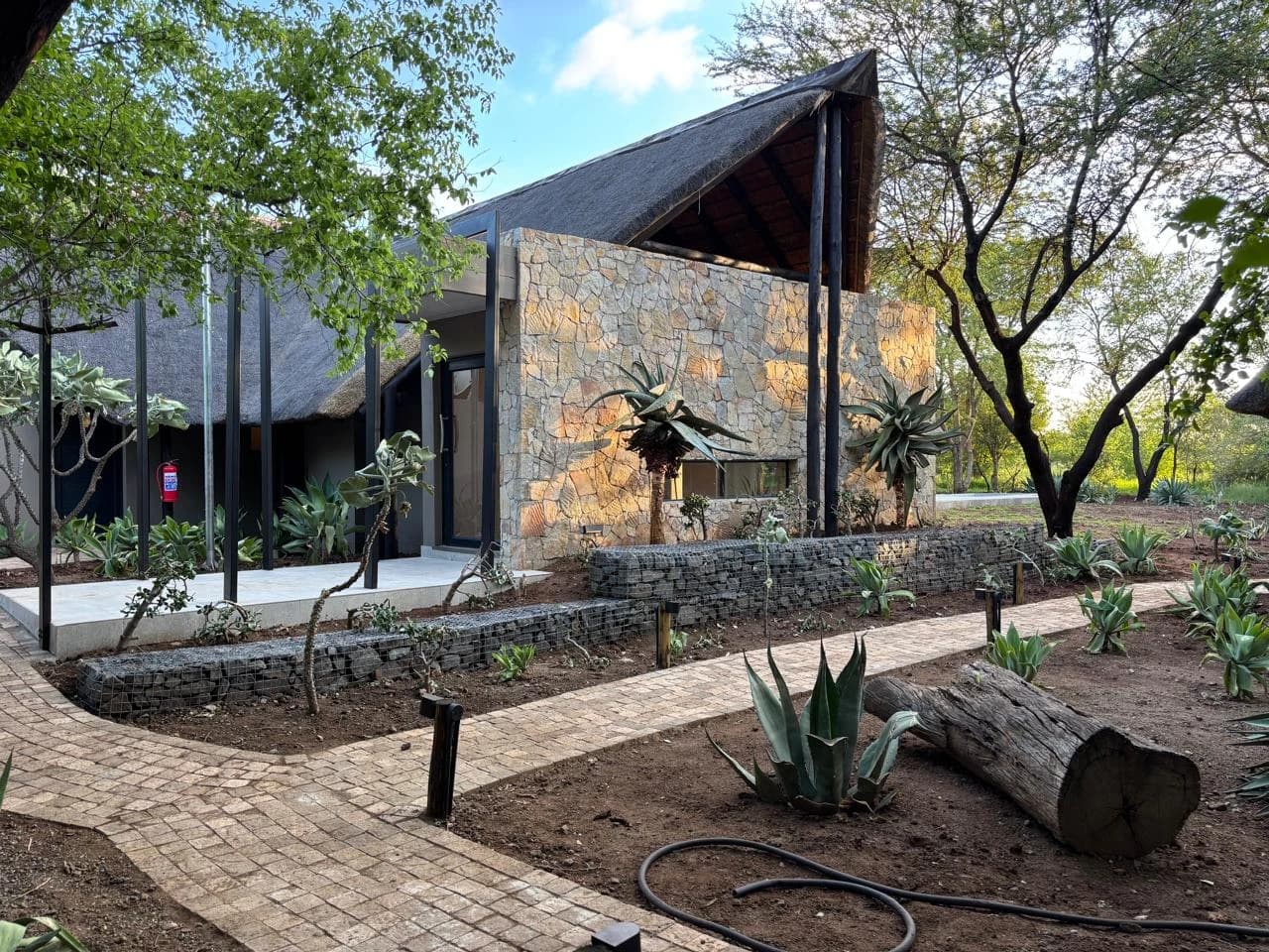 Black Rhino — stone exterior within the wooded landscape